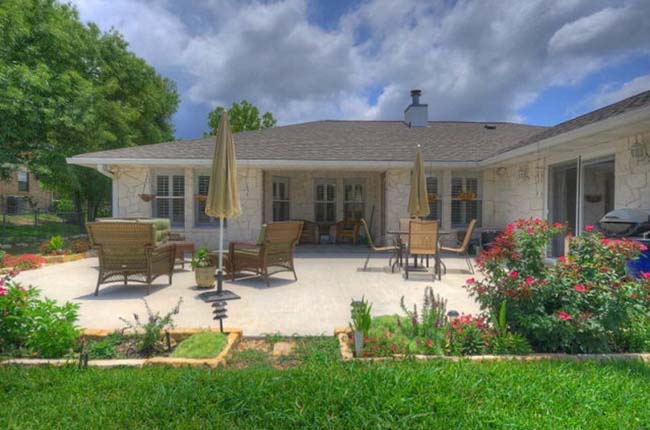 Private covered back patio for outdoor living in Texas Hill Country custom home