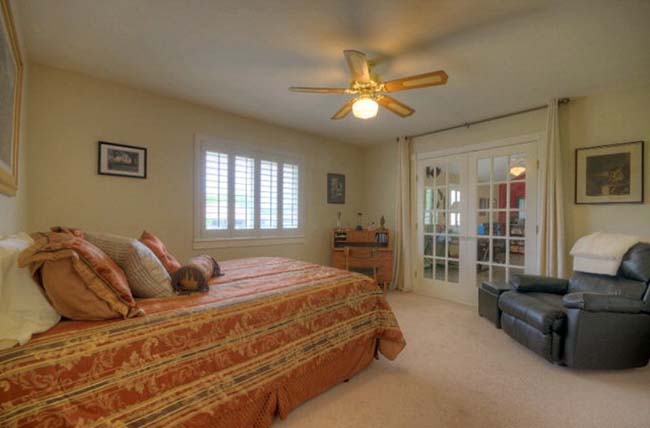 Luxurious master bedroom suite in executive style custom home