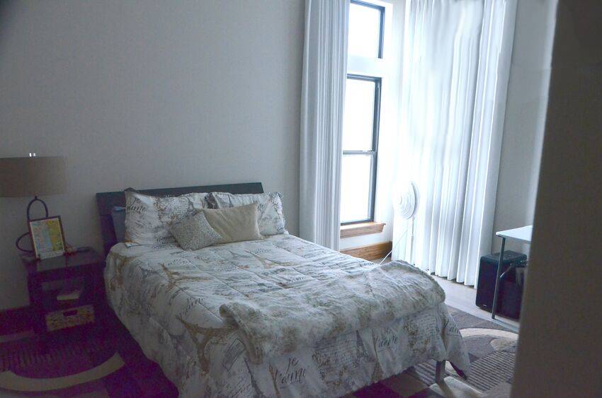 Guest bedroom with floor-to-ceiling windows in modern contemporary home - Riverside Home Designs Custom Home Portfolio