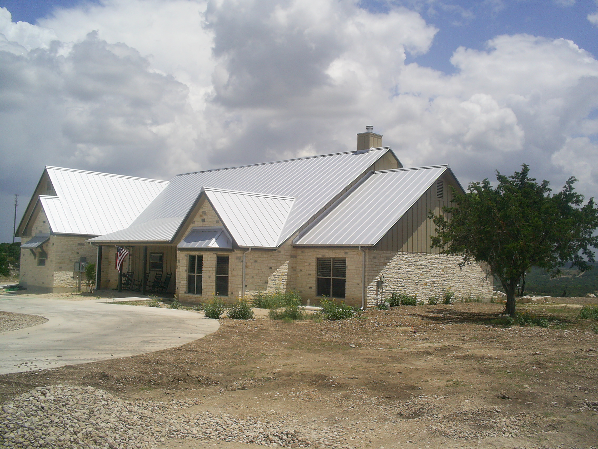 Stone, Steel and Hill Country Views - modern home combining native stone and steel with panoramic landscape views - Riverside Home Designs Custom Home Portfolio